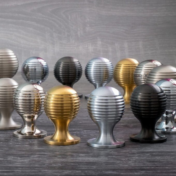 Collection of metallic decorative eggs on wooden surface.