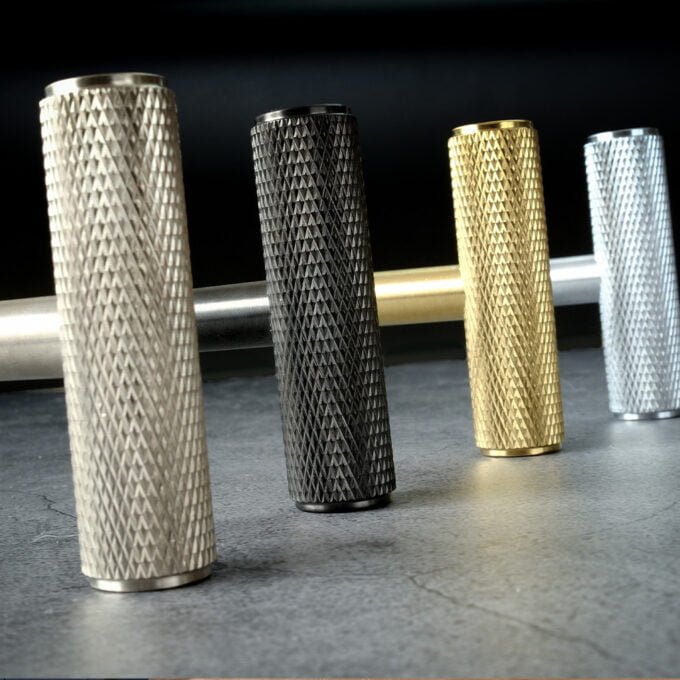 Textured metal grip tubes in silver, black, gold, silver.