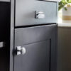 Modern grey kitchen drawer with sleek handles.