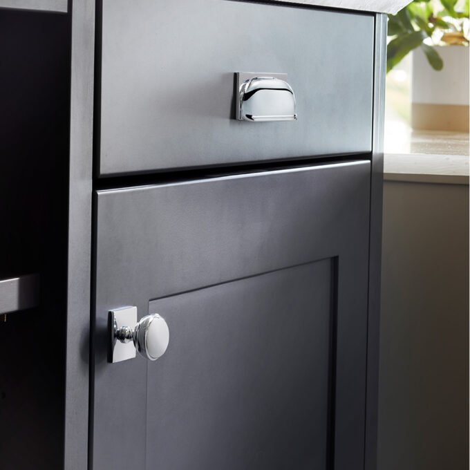 Modern grey kitchen drawer with sleek handles.