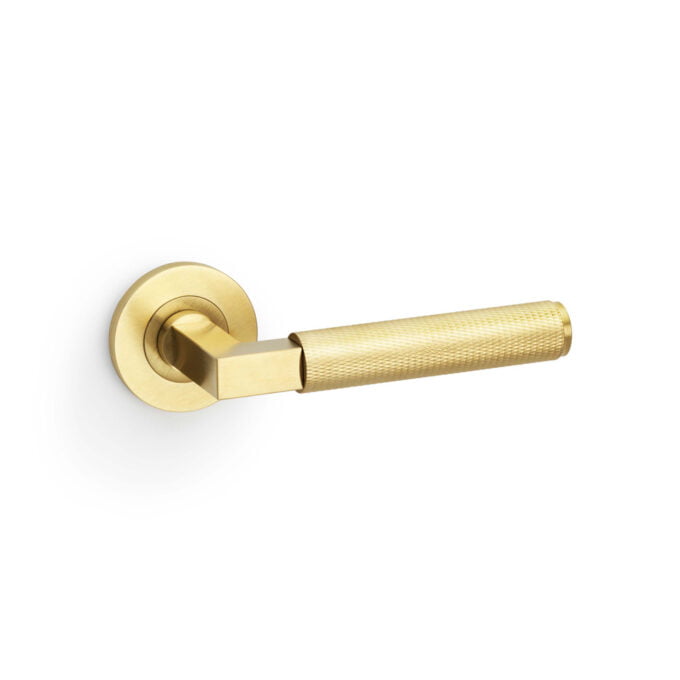 Gold door lever on white background.