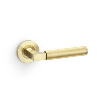 Brass door lever handle on white background