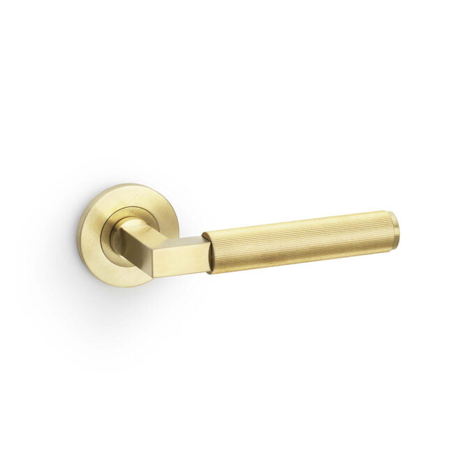 Brass door lever handle on white background