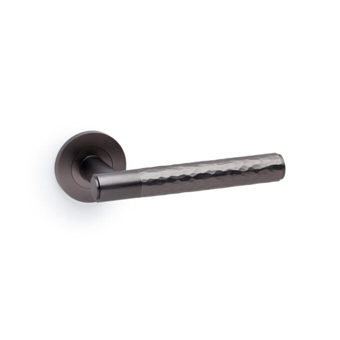 Textured black door handle on white background.