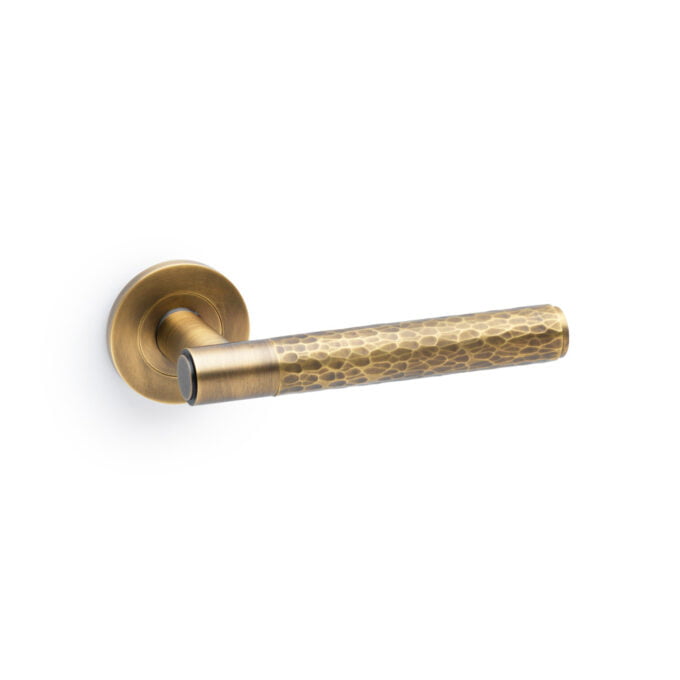 Antique brass door handle on white background.