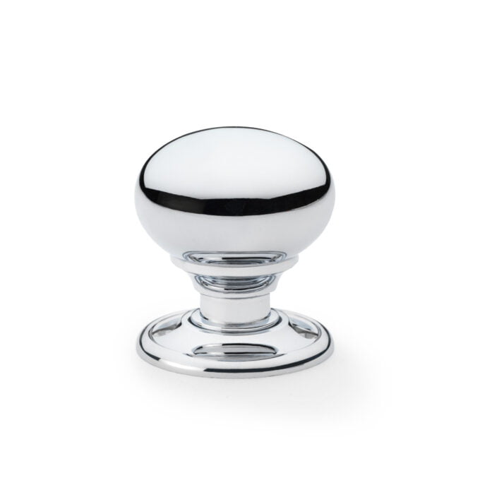 Chrome and glass round cabinet knob on white.