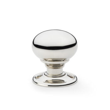 Glass and chrome cabinet knob on white background.