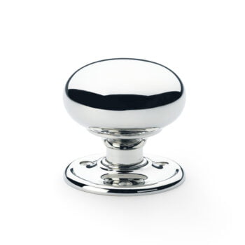 Polished chrome door knob on white background.