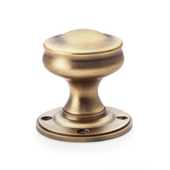 Antique brass door handle on white background.