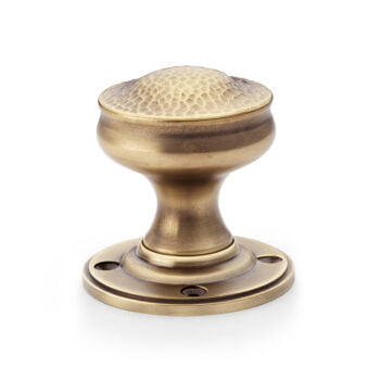 Antique brass door knob on white background.