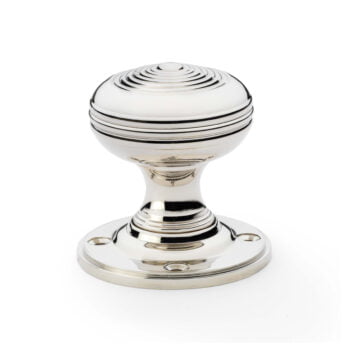 Polished silver door knob on white background.