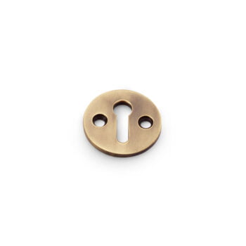 Brass keyhole cover on white background