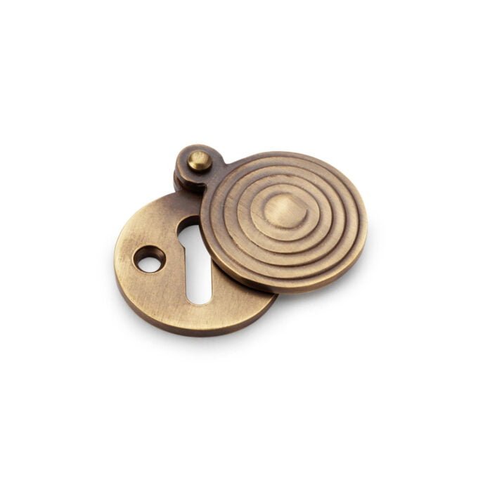 Bronze circular keyhole cover on white background.