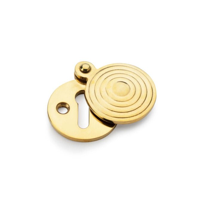 Golden circular keyhole cover on white background