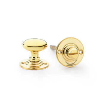 Polished gold cabinet knobs on white background