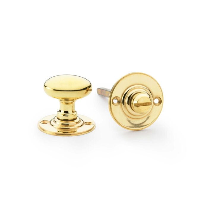 Polished gold cabinet knobs on white background