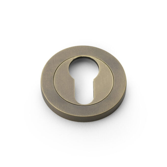 Brass keyhole cover on white background