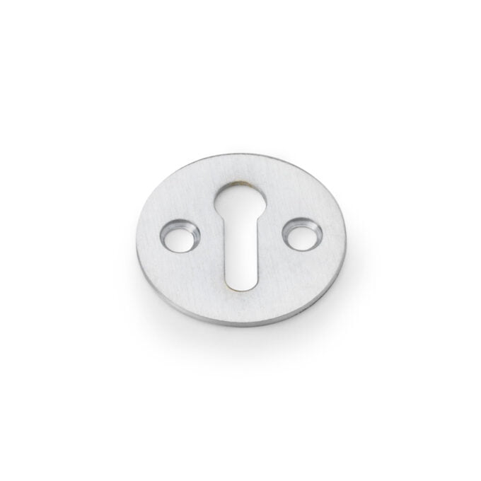 Stainless steel keyhole escutcheon plate isolated on white.