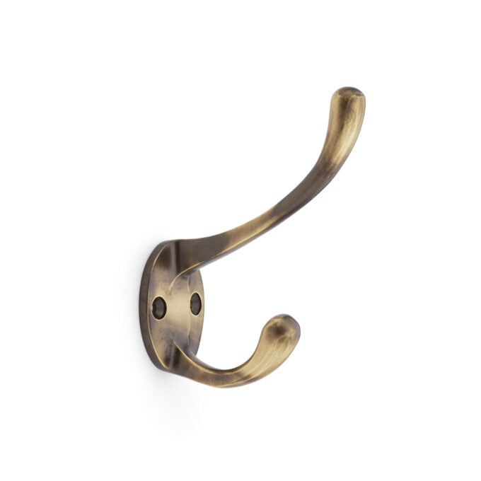 Antique brass wall hook on white background.