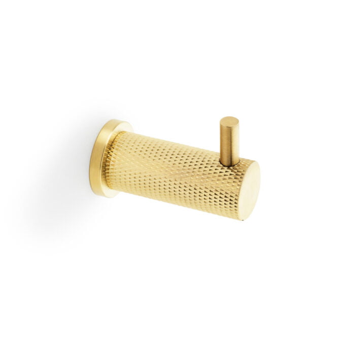 Gold textured cylindrical cabinet handle on white background.