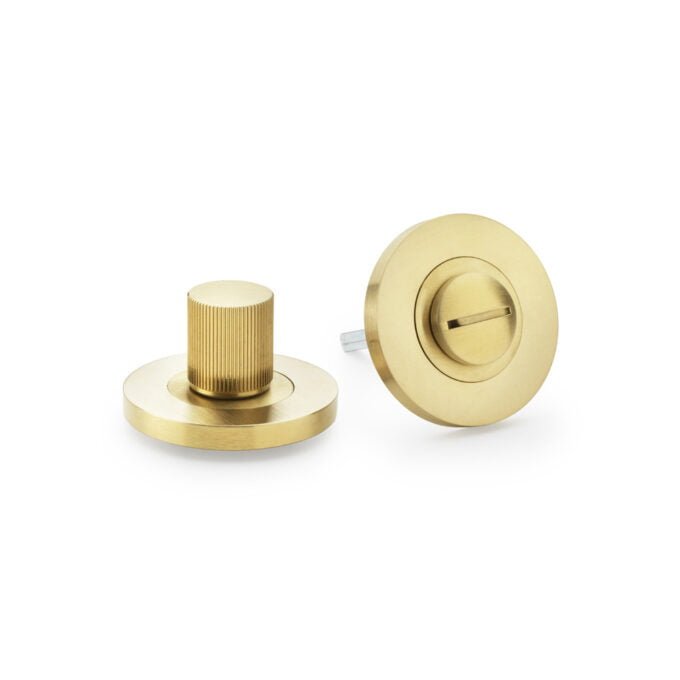 Brass door knobs with textured and smooth designs.