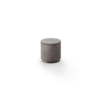 Grey knurled metal knob on white background