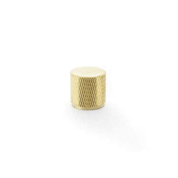 Gold knurled small cabinet knob on white background.