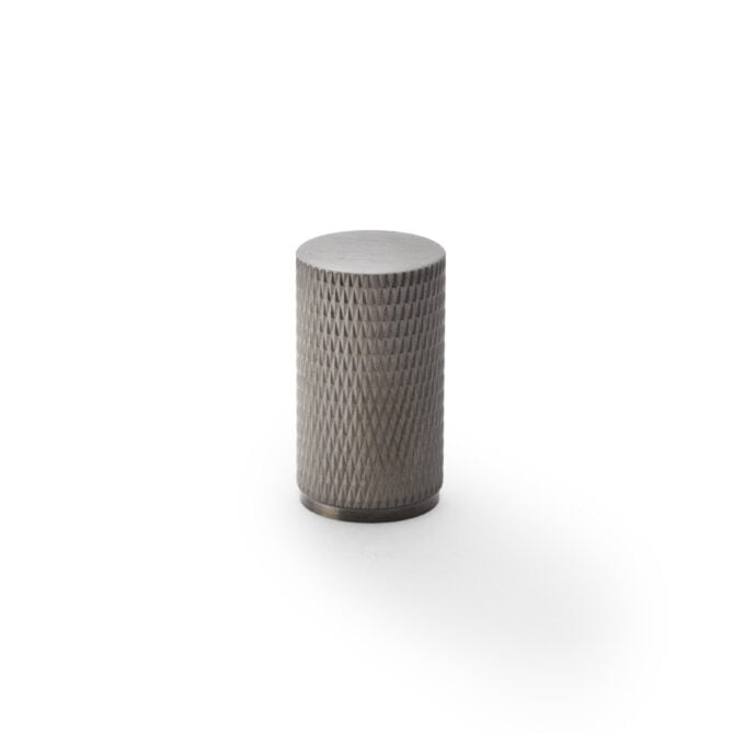 Textured grey cylindrical object on white background