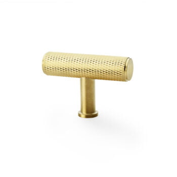 Gold textured cabinet handle on white background.