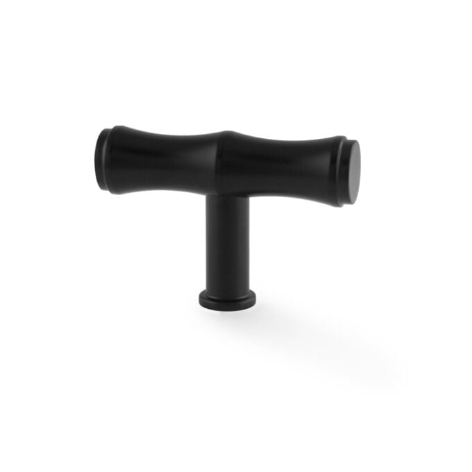 Black T-shaped plastic pipe fitting on white background.