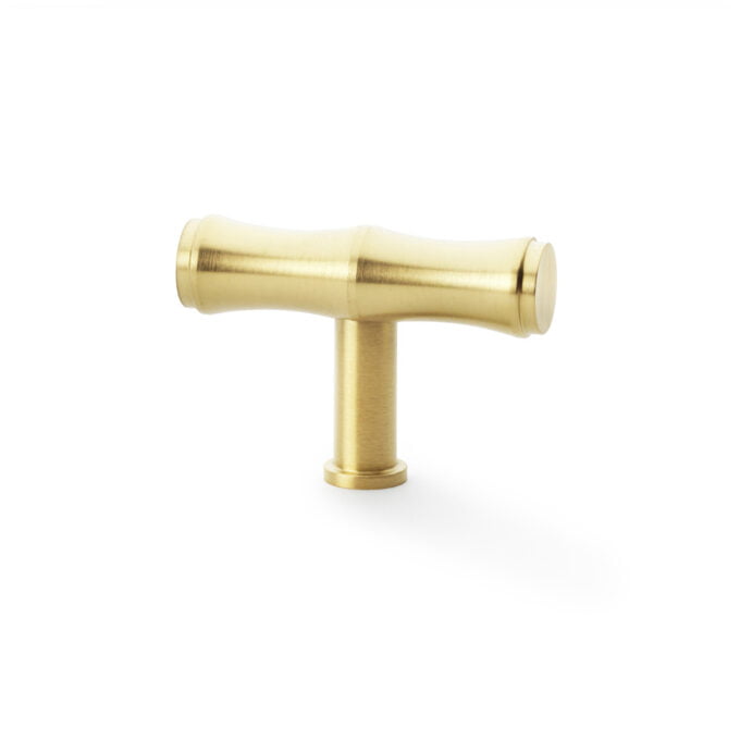 Gold T-shaped plumbing pipe on white background.