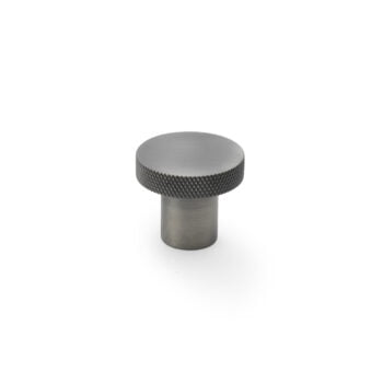 Metallic knob with textured top on white background