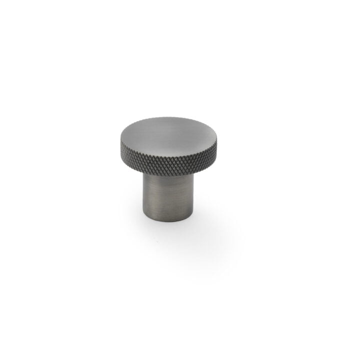 Metallic knob with textured top on white background