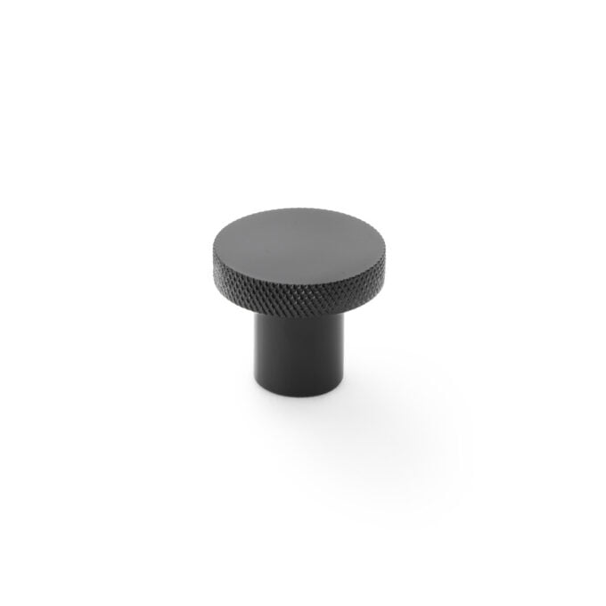 Black textured knob on white background.