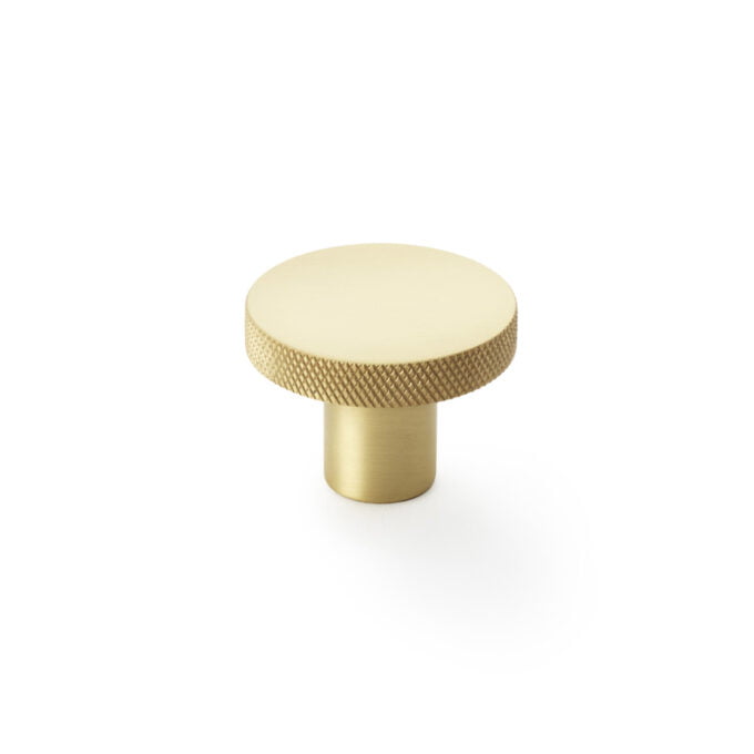 Gold textured cabinet knob on white background