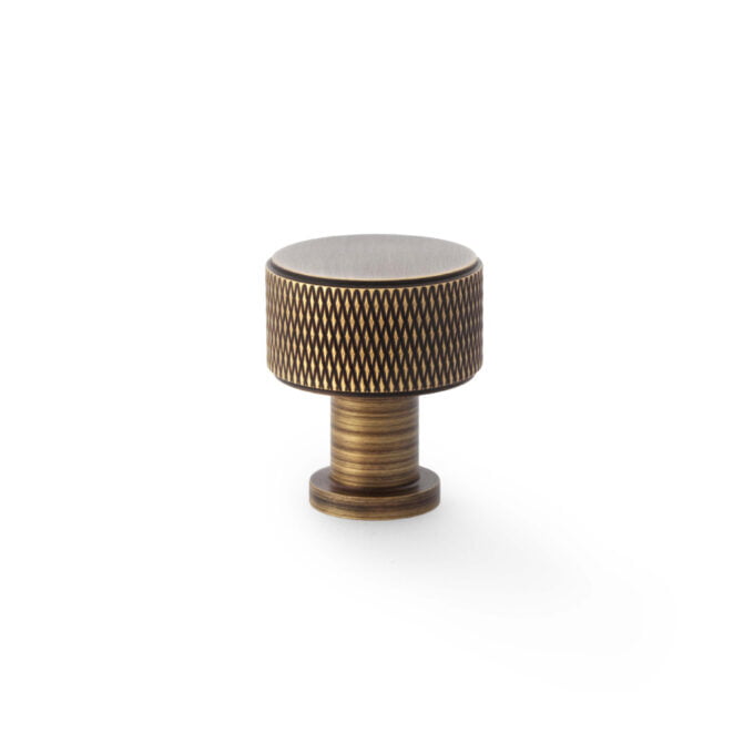 Textured brass cabinet knob on white background
