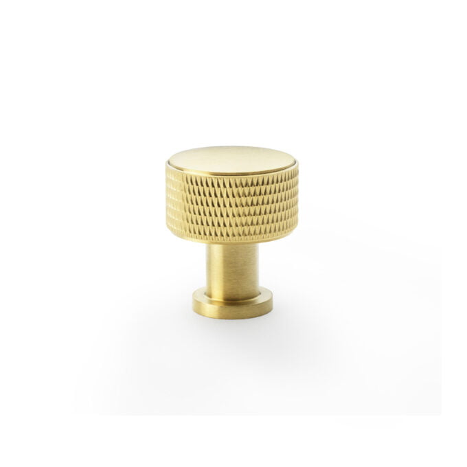 Gold textured cabinet knob on white background.