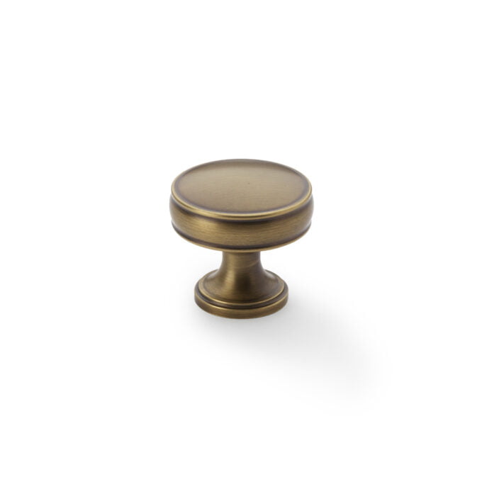 Antique bronze cabinet knob on white background.