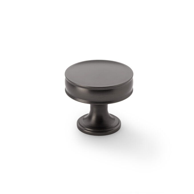 Black metal cabinet knob on white background.