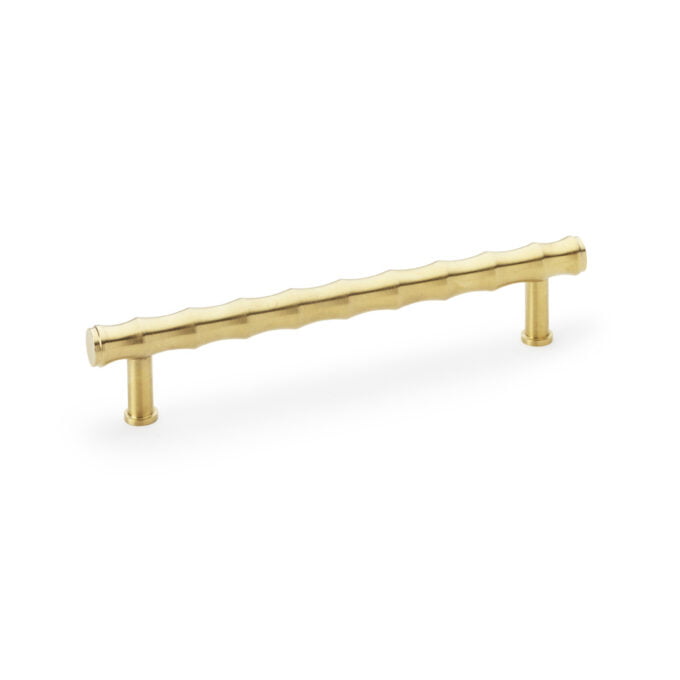 Gold cabinet handle on white background.