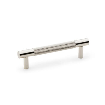 Chrome cabinet handle with textured grip on white.