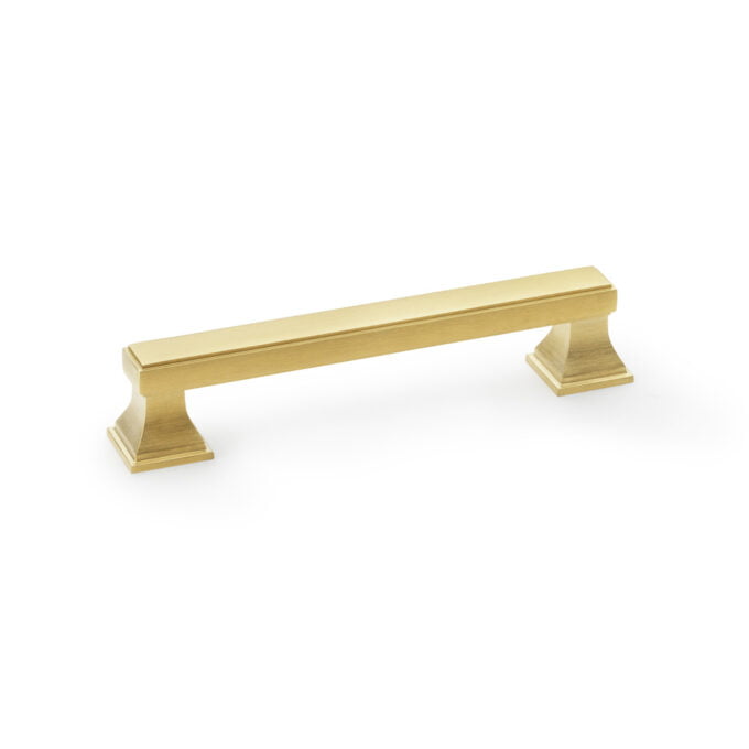 Gold cabinet handle on white background.