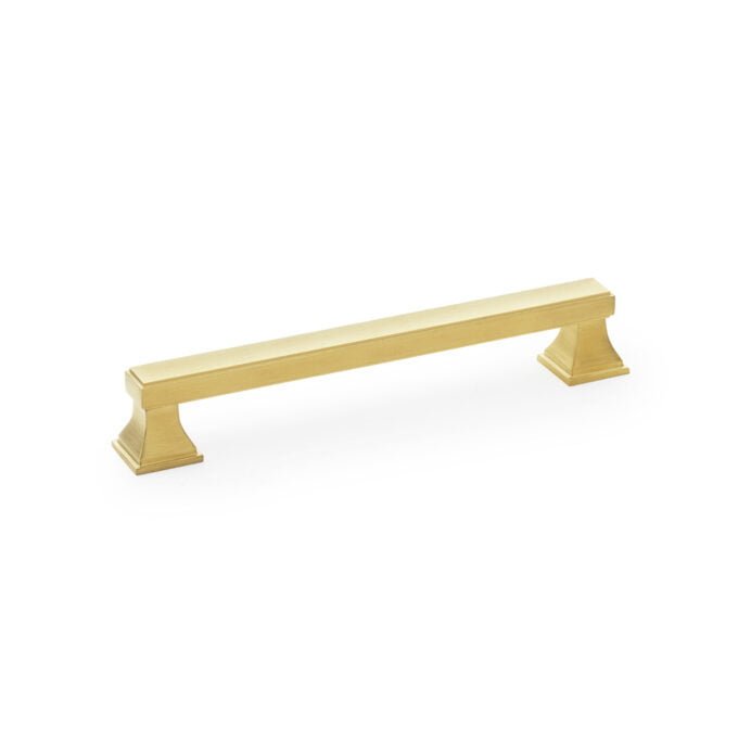 Gold cabinet handle on white background.