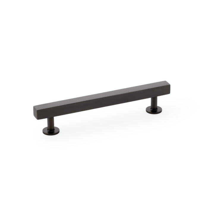 Black modern cabinet handle on white background.