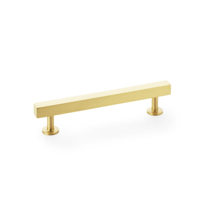 Gold cabinet handle on white background.