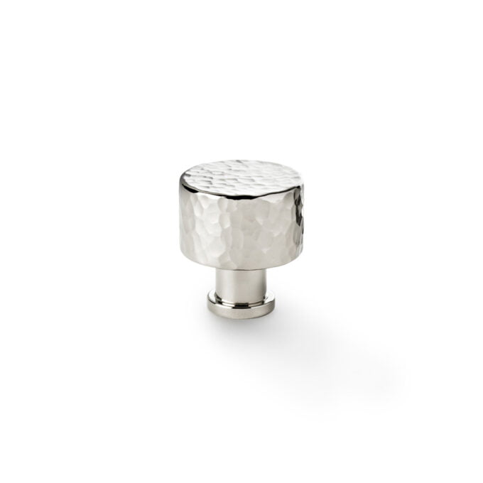 Hammered silver cabinet knob on white background.