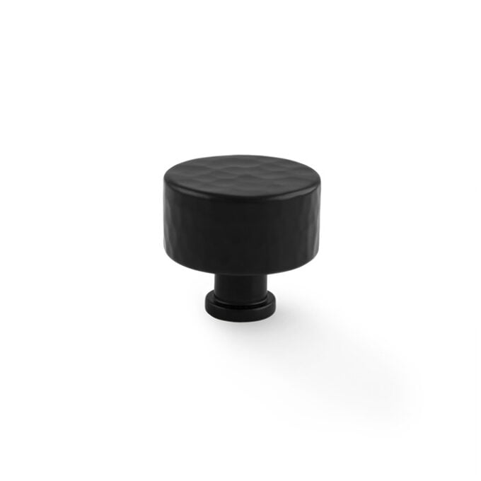 Black round cabinet knob on white background