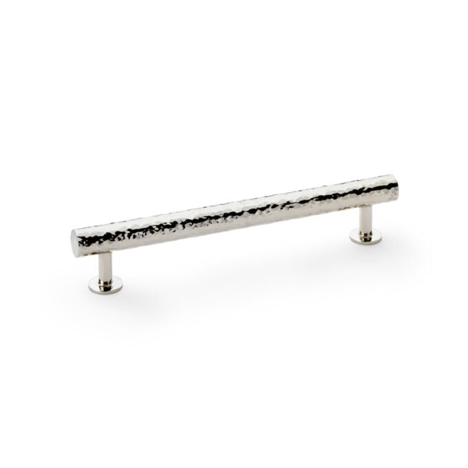 Silver hammered cabinet handle on white background.