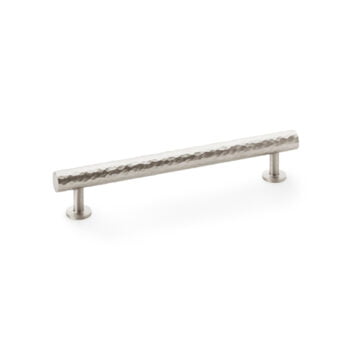 Hammered metal cabinet handle on white background.