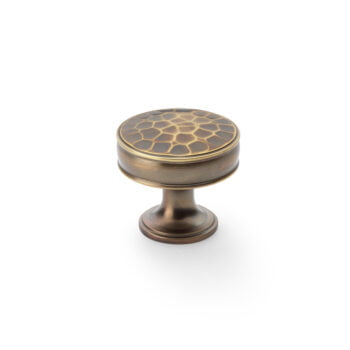 Bronze cabinet knob with honeycomb pattern on white background